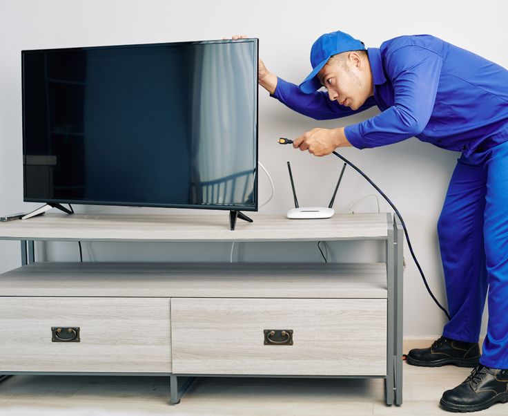 Indian technician fixing Sony OLED TV screen