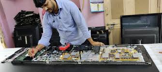 Indian technician installing smart TV on wall