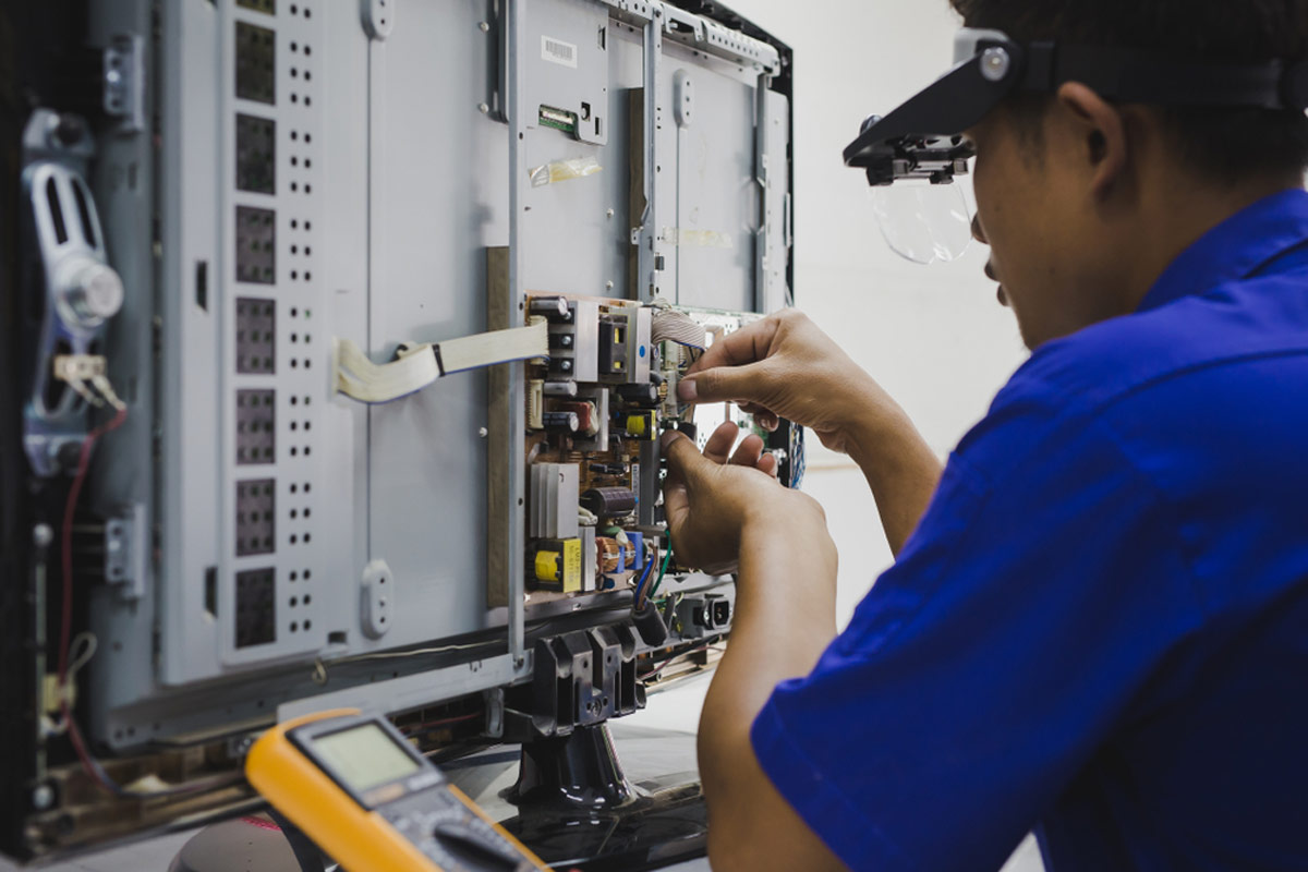 Technician fixing TV
